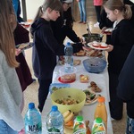 Uczniowie na korytarzu przygotowujący stół.