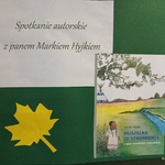 Plakat reklamujący spotkanie autorskie.